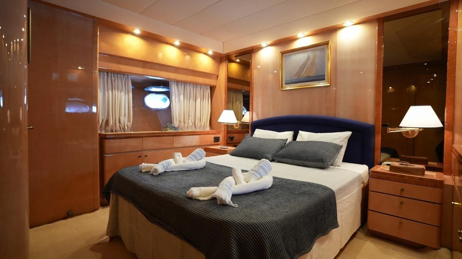 The master stateroom features a luxurious bed with elegant lighting and decor. aboard TWINS PC Yacht for Sale