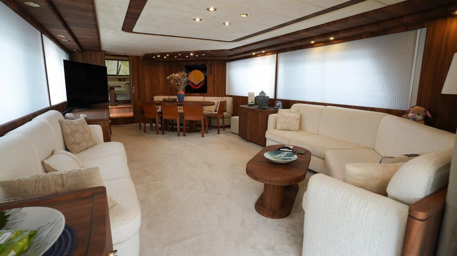 The yacht's salon features plush seating, a dining area, and elegant wood finishes, creating a warm and inviting atmosphere. aboard TWINS PC Yacht for Sale
