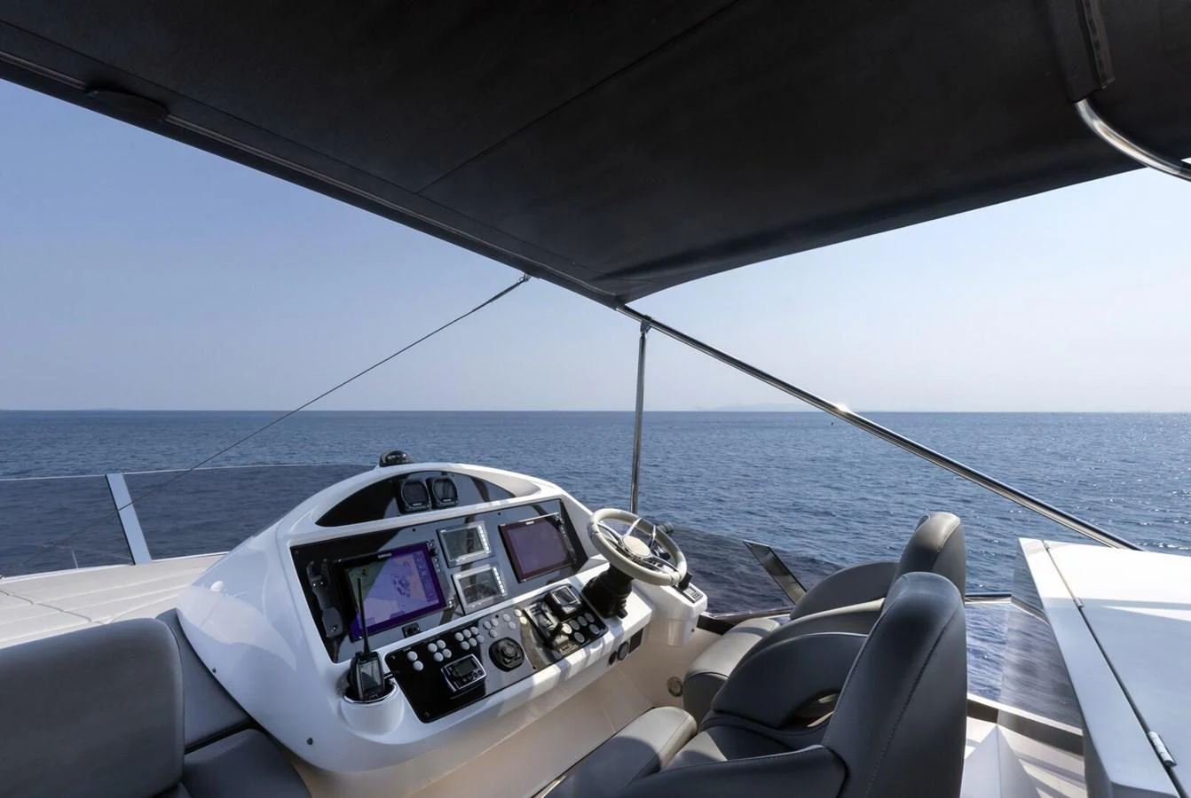 The helm station offers a commanding view of the open sea, equipped with advanced navigation systems. aboard "CORAZON DE LEON" Yacht for Sale