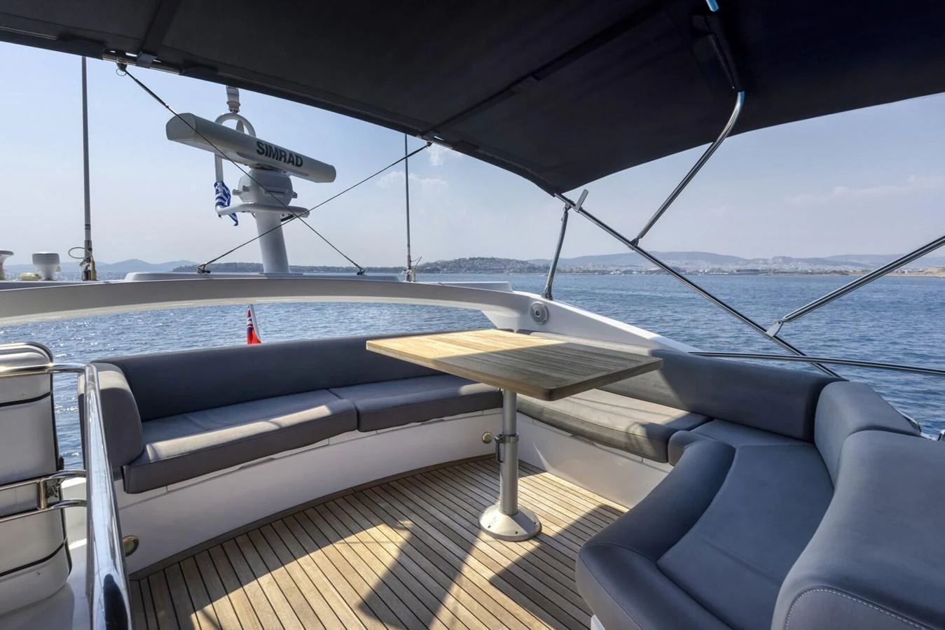 The flybridge offers a spacious seating area with a table, perfect for enjoying the sea views. aboard "CORAZON DE LEON" Yacht for Sale