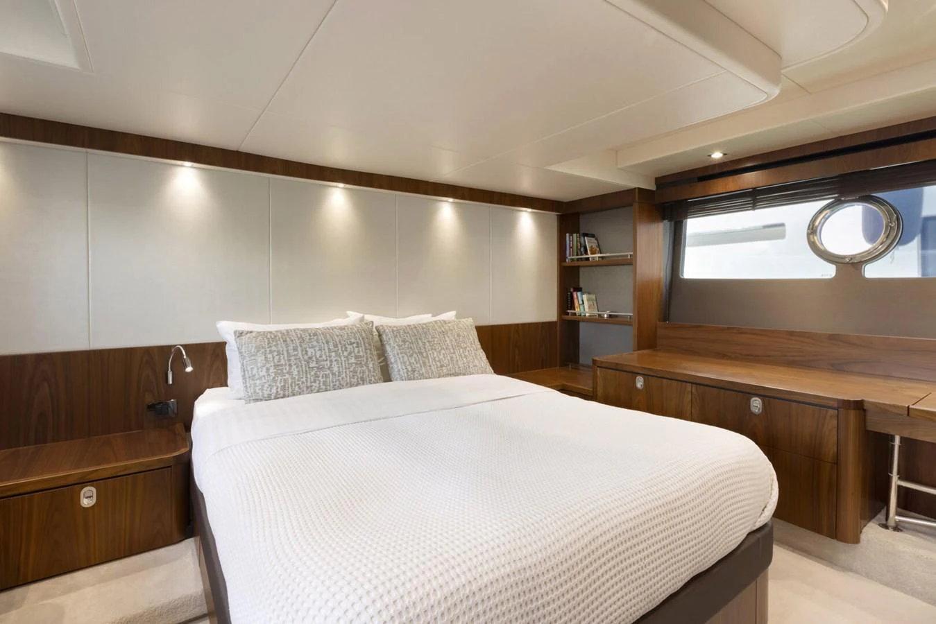 The master stateroom features a spacious bed with elegant wood paneling and modern lighting. aboard "CORAZON DE LEON" Yacht for Sale