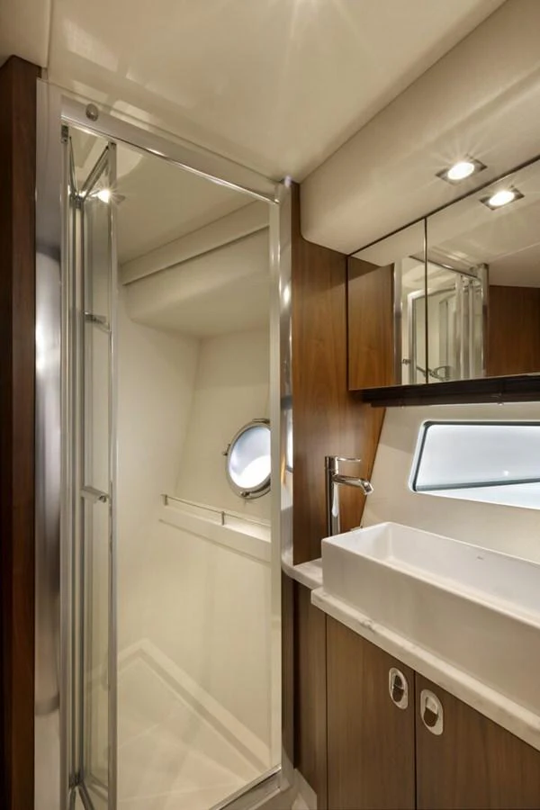 The yacht's bathroom features a sleek design with a modern sink and a glass-enclosed shower. aboard "CORAZON DE LEON" Yacht for Sale
