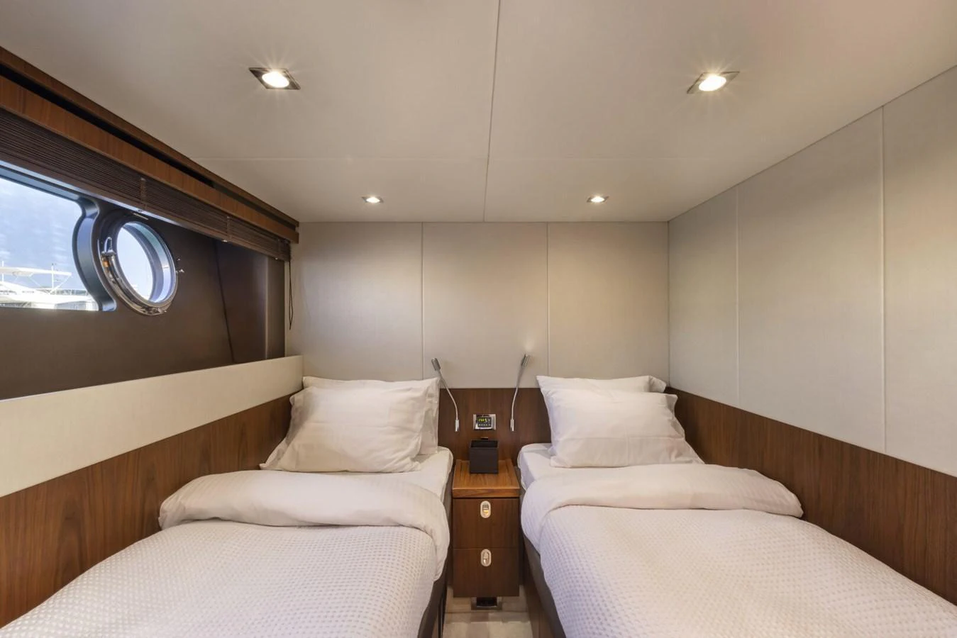 The twin stateroom offers a cozy and comfortable sleeping arrangement with two single beds and elegant wood paneling. aboard "CORAZON DE LEON" Yacht for Sale