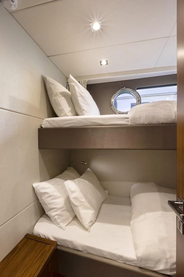 The cozy guest cabin features comfortable bunk beds with plush pillows and bedding. aboard "CORAZON DE LEON" Yacht for Sale