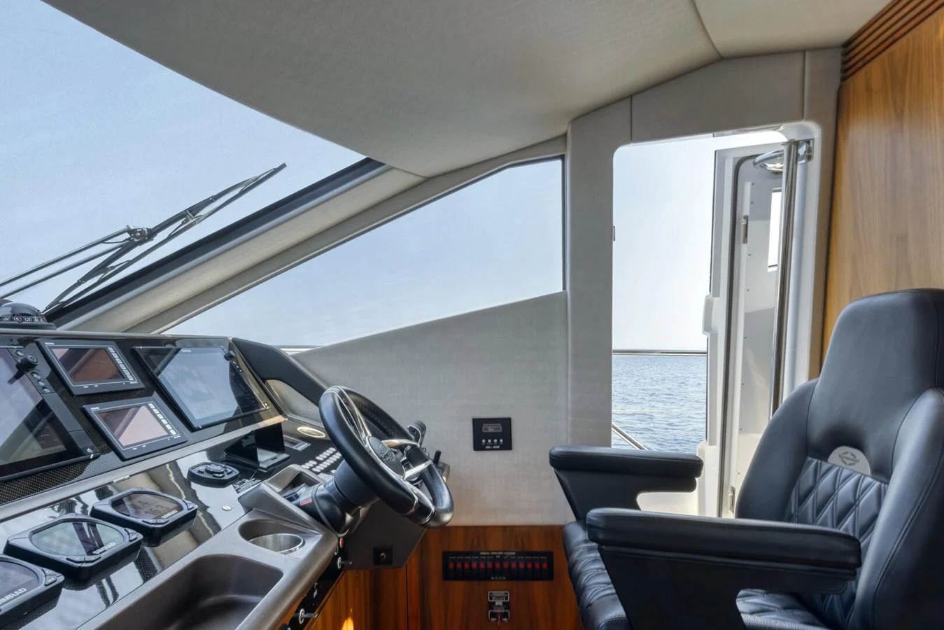 The helm station offers a commanding view with modern navigation equipment and a comfortable captain's chair. aboard "CORAZON DE LEON" Yacht for Sale