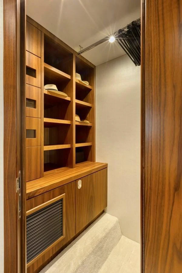 A beautifully crafted wooden closet with ample storage space and elegant lighting. aboard "CORAZON DE LEON" Yacht for Sale