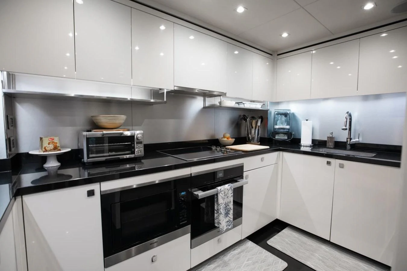 The yacht's galley features modern appliances and sleek cabinetry, creating a stylish and functional space for meal preparation. aboard 95 FT 2018 SUNSEEKER 95 YACHT, MIRRACLE Yacht for Sale