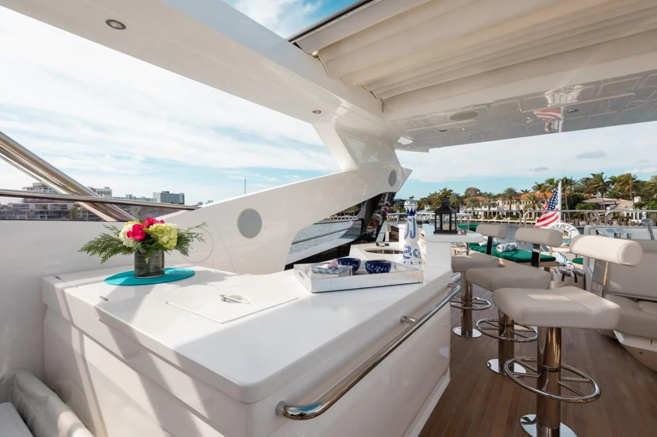 The aft deck features a stylish bar area with comfortable seating and a scenic view. aboard 95 FT 2018 SUNSEEKER 95 YACHT, MIRRACLE Yacht for Sale