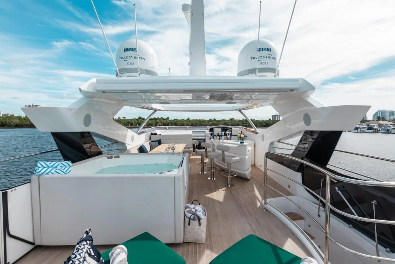 The yacht's aft deck features a luxurious lounging area with a jacuzzi and bar, perfect for relaxation and entertainment. aboard 95 FT 2018 SUNSEEKER 95 YACHT, MIRRACLE Yacht for Sale
