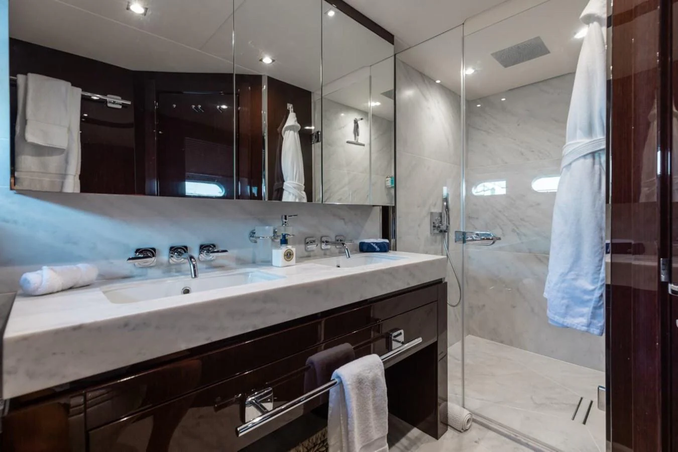 The yacht's bathroom features a luxurious marble countertop and a spacious glass-enclosed shower. aboard 95 FT 2018 SUNSEEKER 95 YACHT, MIRRACLE Yacht for Sale