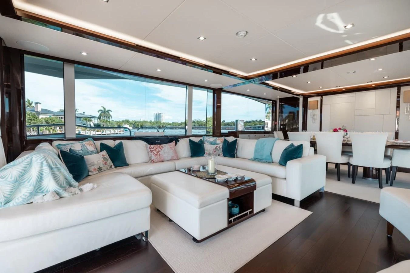 The salon features a spacious and elegantly decorated seating area with large windows offering panoramic views. aboard 95 FT 2018 SUNSEEKER 95 YACHT, MIRRACLE Yacht for Sale