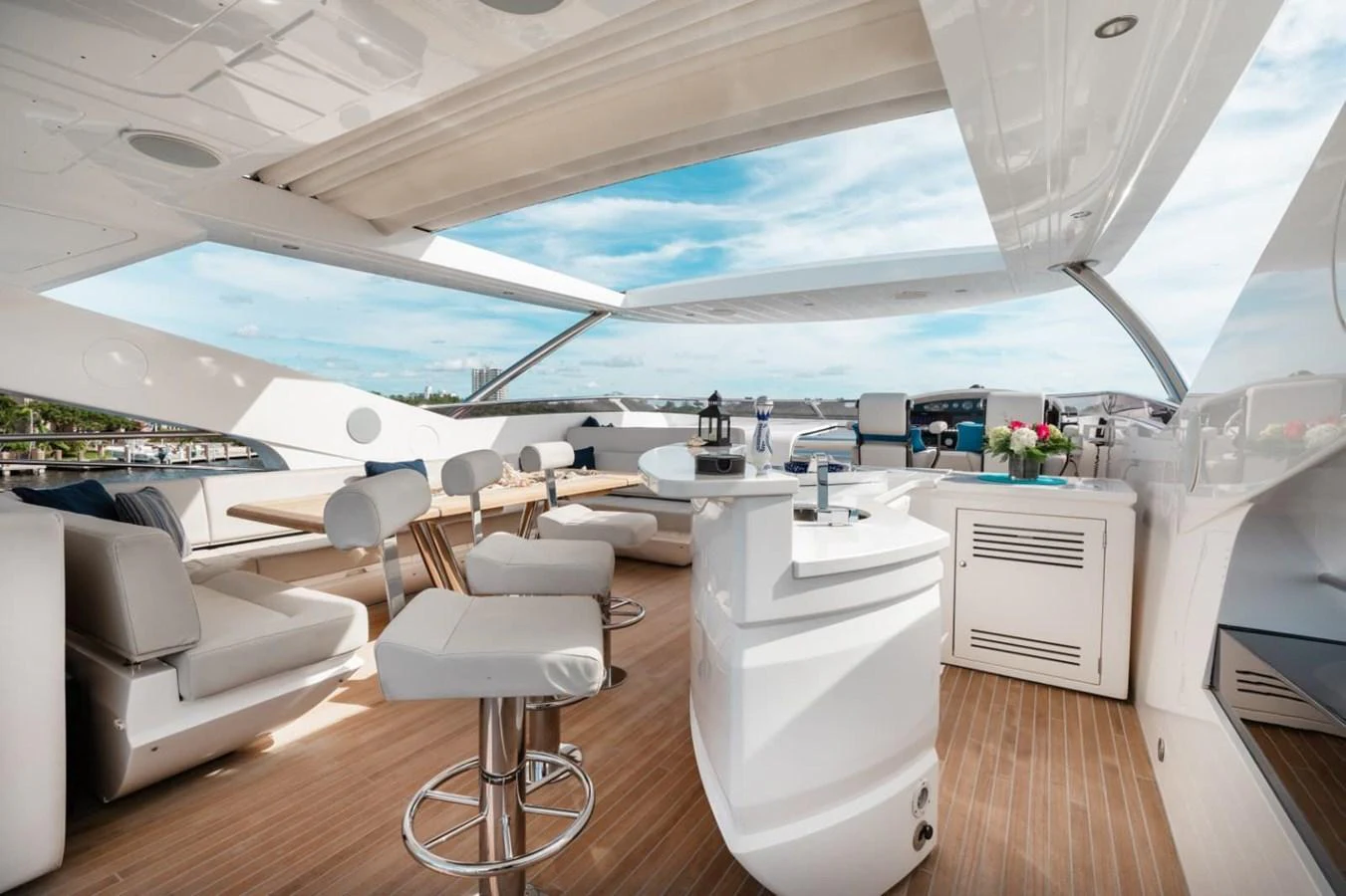The flybridge offers a luxurious open-air space with modern seating and a sleek bar area. aboard 95 FT 2018 SUNSEEKER 95 YACHT, MIRRACLE Yacht for Sale