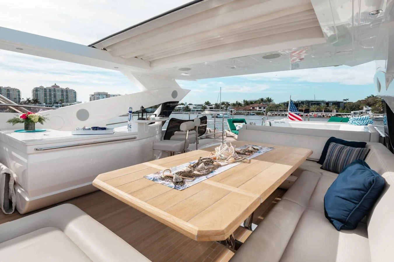 The aft deck features a spacious dining area with a wooden table and comfortable seating, perfect for alfresco meals. aboard 95 FT 2018 SUNSEEKER 95 YACHT, MIRRACLE Yacht for Sale