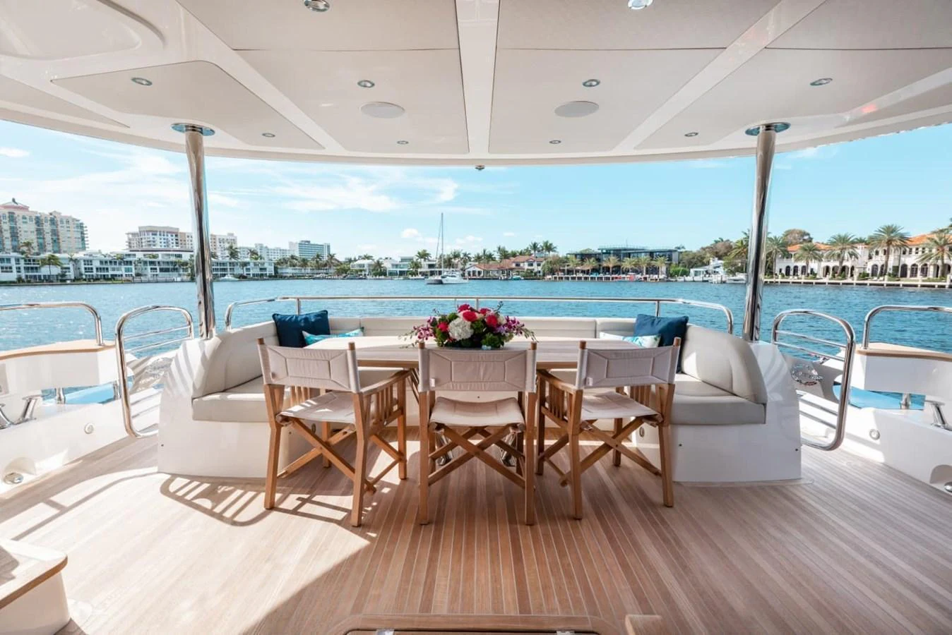 The aft deck features a stylish dining area with a beautiful waterfront view. aboard 95 FT 2018 SUNSEEKER 95 YACHT, MIRRACLE Yacht for Sale