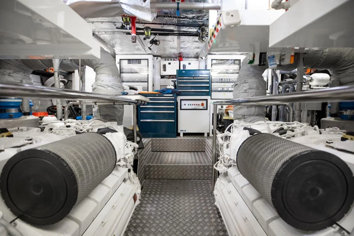 The image showcases a well-organized engine room with twin engines and various mechanical components. aboard 95 FT 2018 SUNSEEKER 95 YACHT, MIRRACLE Yacht for Sale