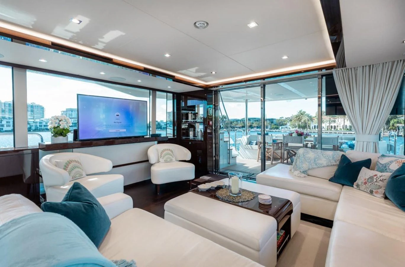 The salon features luxurious seating with a view of the marina through large windows. aboard 95 FT 2018 SUNSEEKER 95 YACHT, MIRRACLE Yacht for Sale