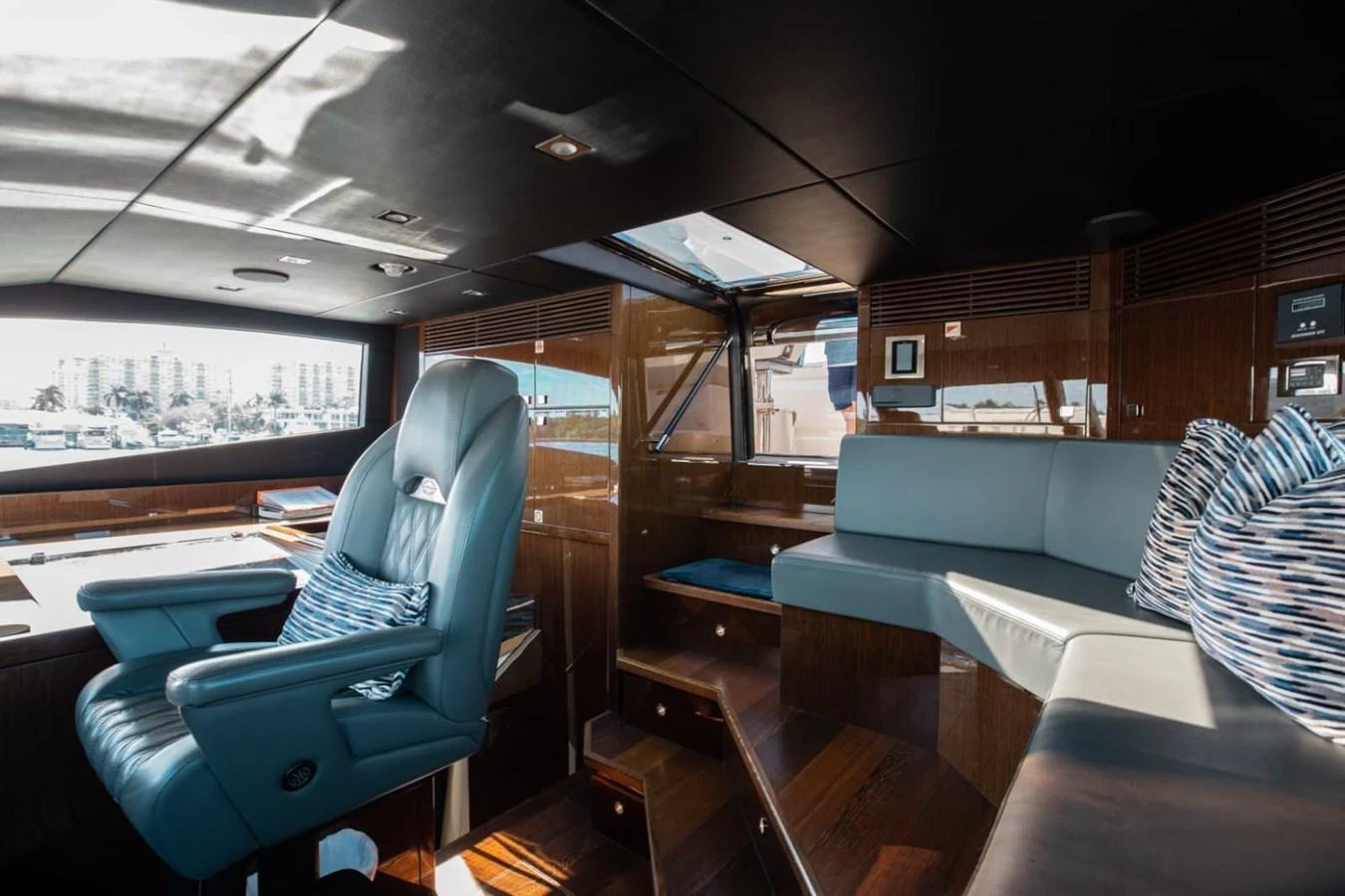The helm area features luxurious seating and a sleek, modern design with rich wood finishes. aboard 95 FT 2018 SUNSEEKER 95 YACHT, MIRRACLE Yacht for Sale