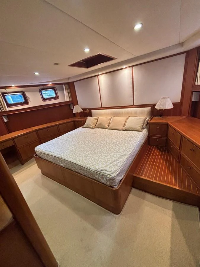 A cozy stateroom featuring a comfortable bed and ample storage space. aboard REX AQUILA Yacht for Sale
