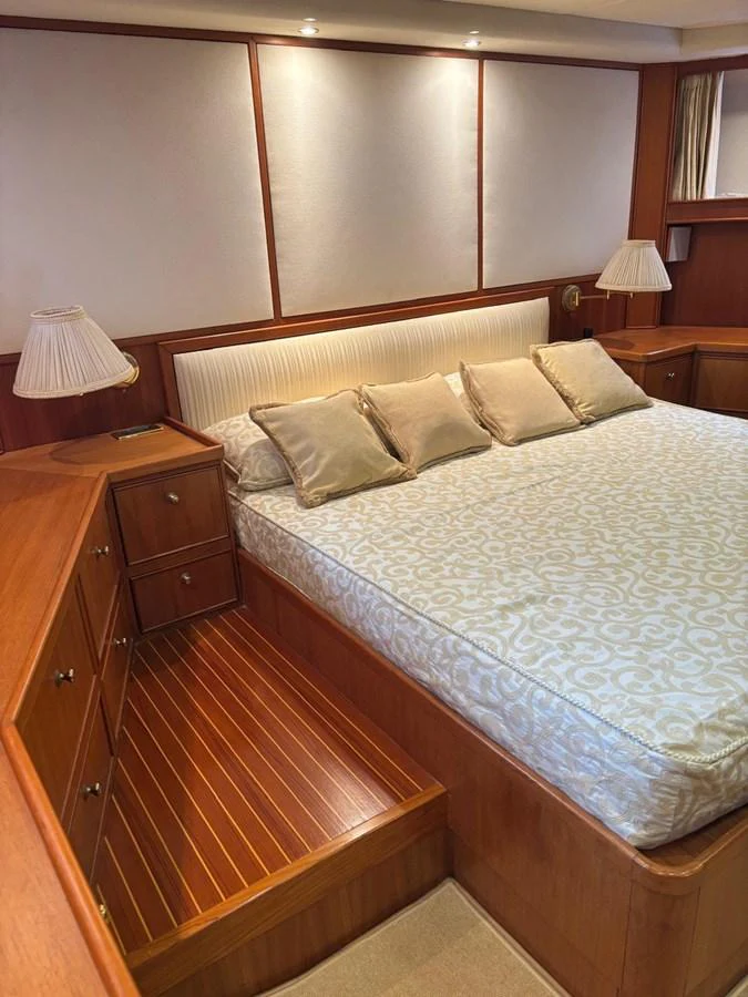 The stateroom features a comfortable bed with elegant bedding and ample storage space. aboard REX AQUILA Yacht for Sale