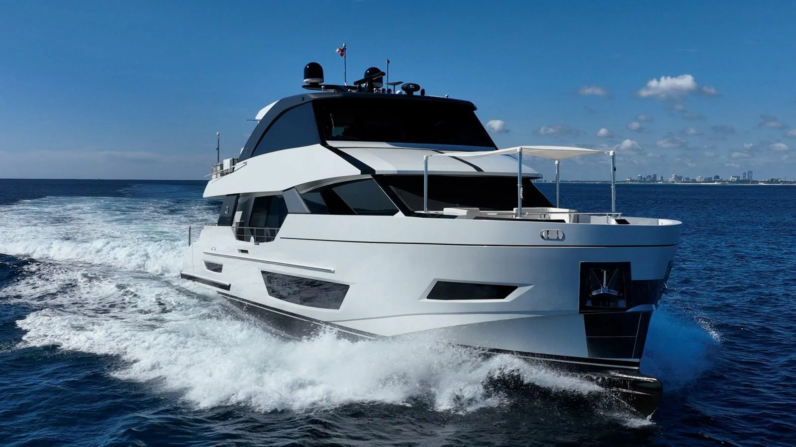 A sleek, modern yacht cruising through the open water on a clear day. aboard AQUASITION Yacht for Sale
