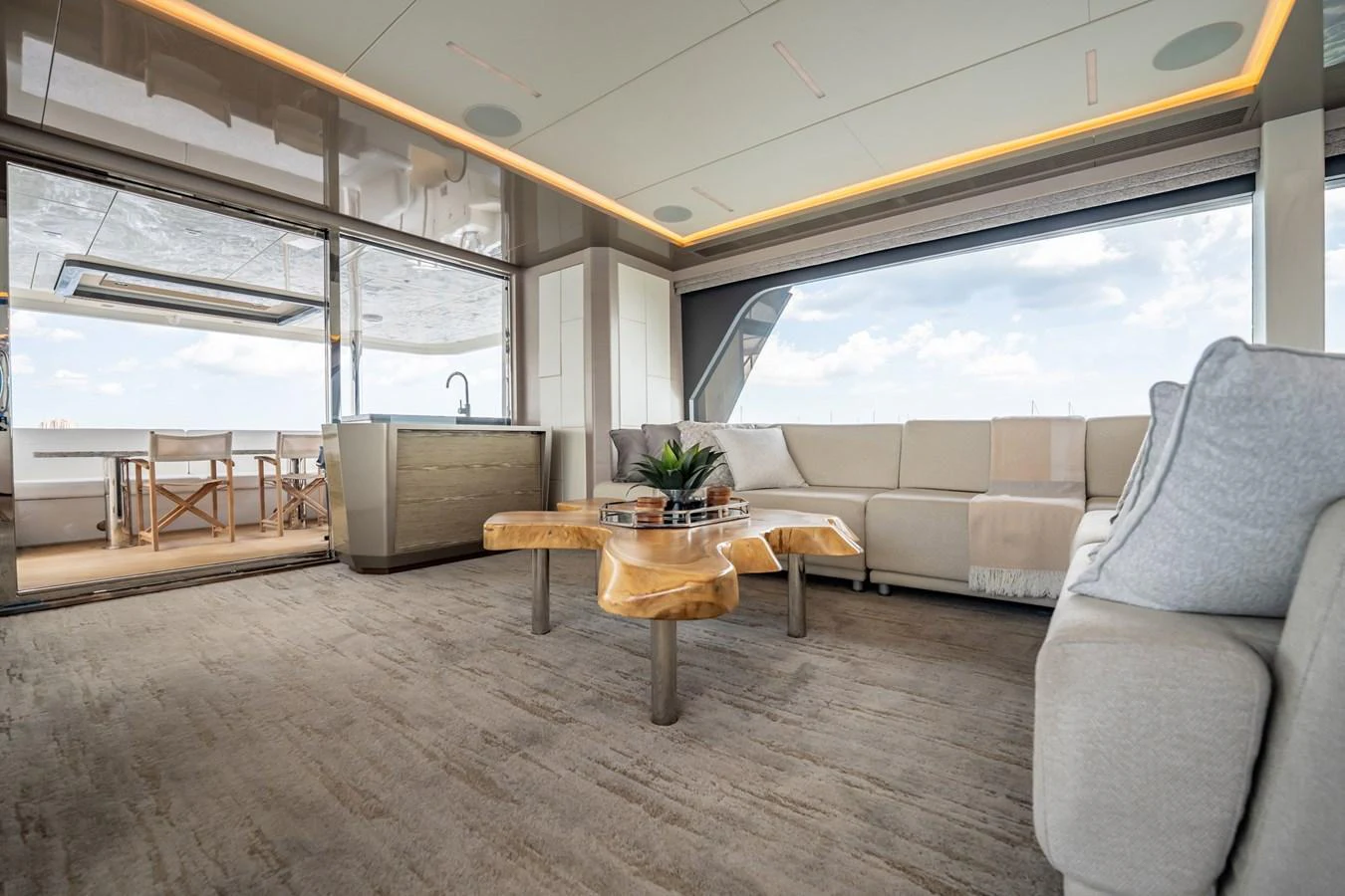 The spacious salon features elegant furnishings and large windows offering panoramic views. aboard AQUASITION Yacht for Sale