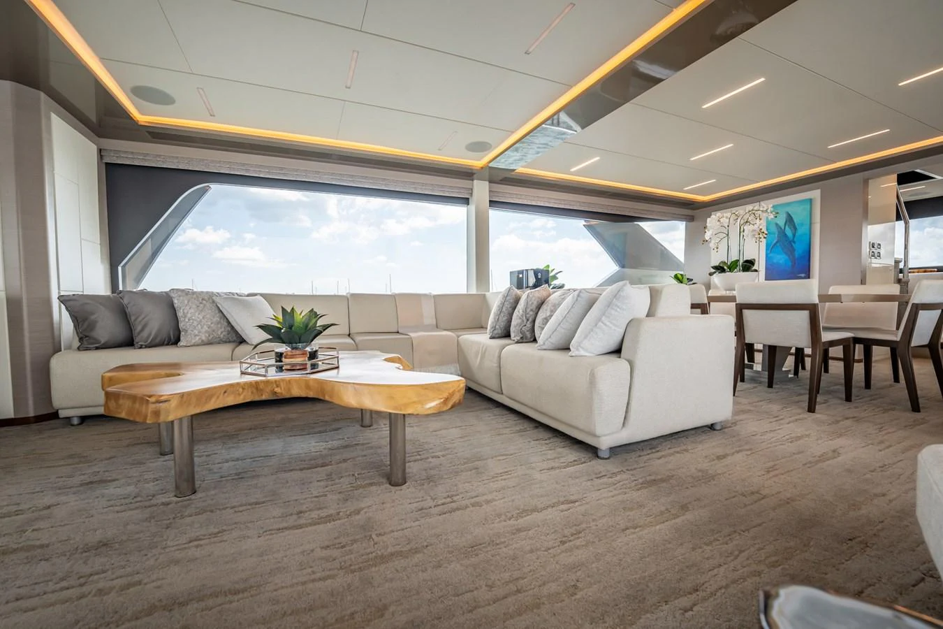 The salon features a spacious seating area with plush sofas and a stylish wooden coffee table, offering a luxurious and comfortable environment. aboard AQUASITION Yacht for Sale