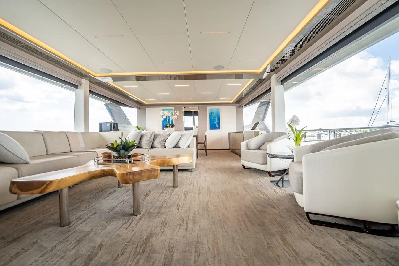 The spacious salon features elegant furnishings and panoramic windows for a luxurious experience. aboard AQUASITION Yacht for Sale