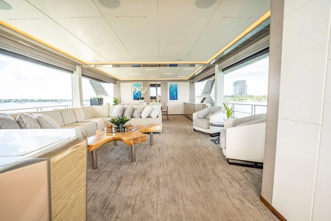 The spacious salon features modern furnishings and large windows for panoramic views. aboard AQUASITION Yacht for Sale
