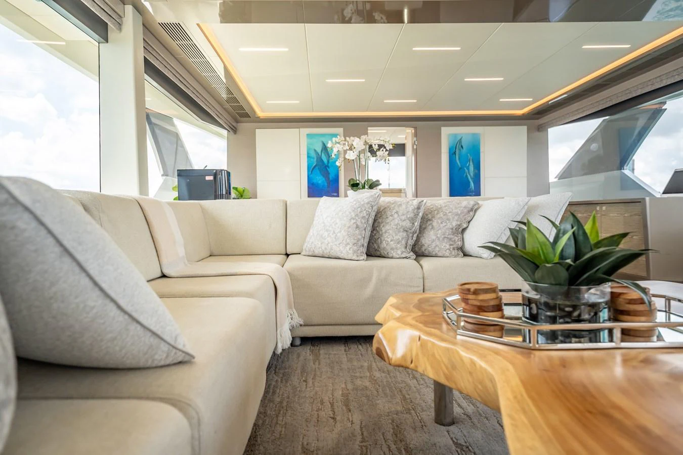 The salon features a spacious and elegant seating area with modern decor and natural light. aboard AQUASITION Yacht for Sale