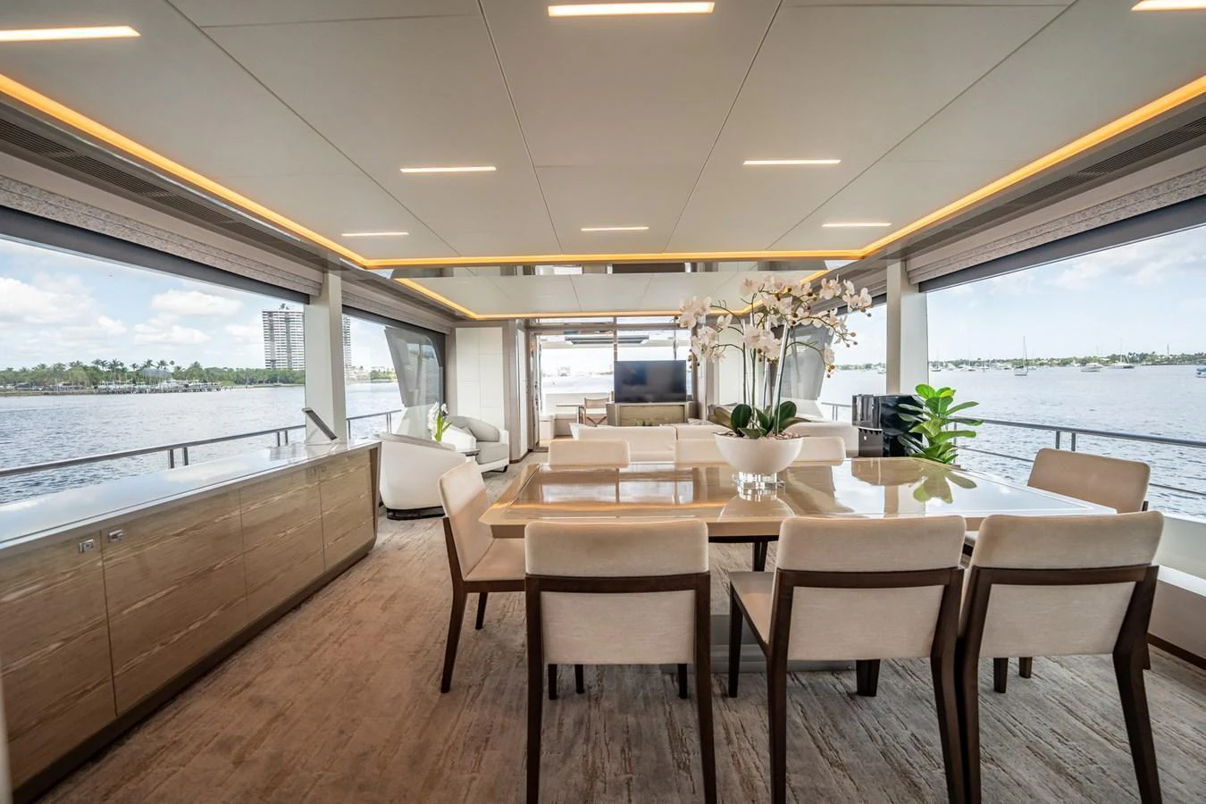 The yacht's dining area offers a spacious and elegant setting with panoramic views of the water. aboard AQUASITION Yacht for Sale