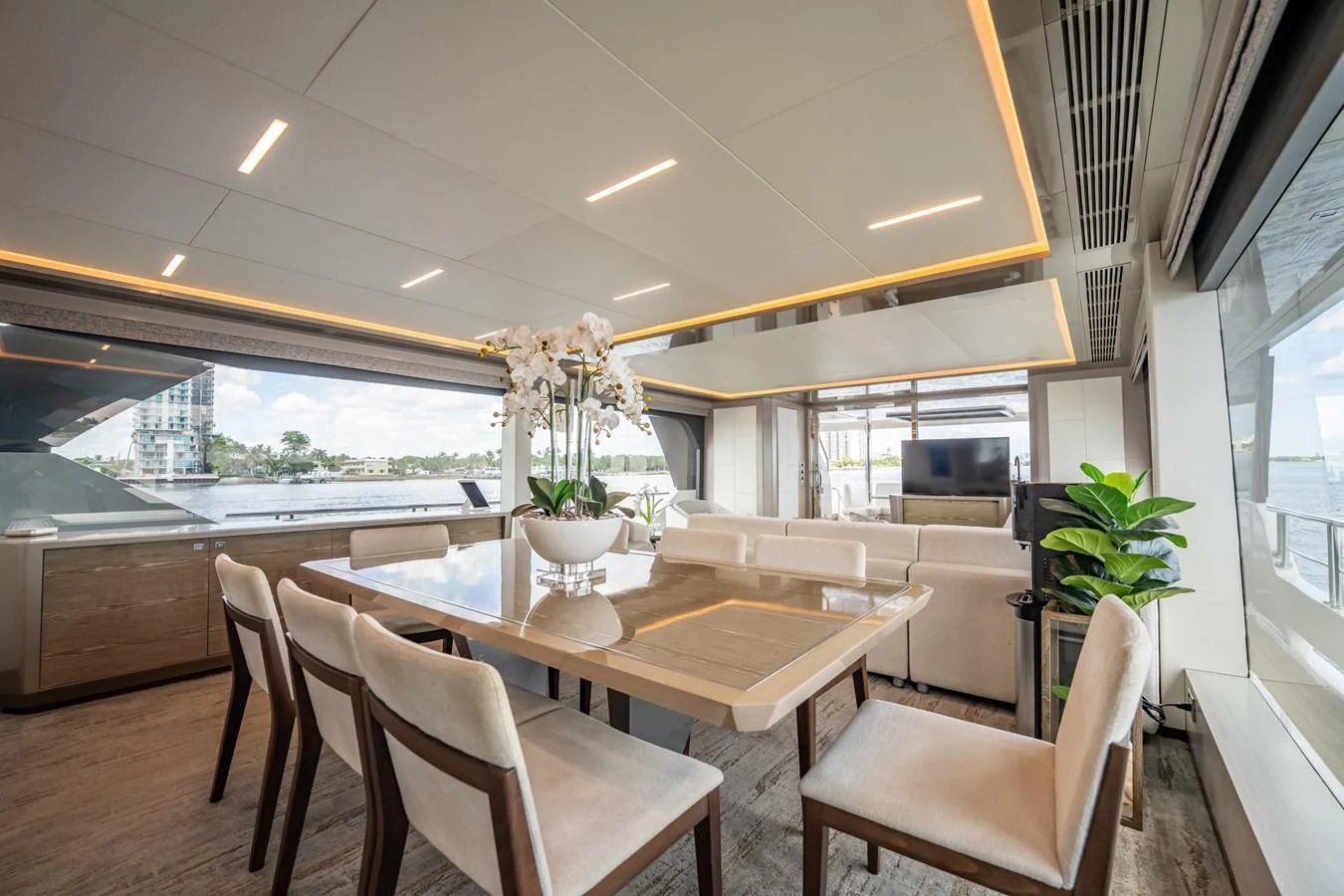 The yacht's dining area features a modern and elegant design with ample natural light and luxurious furnishings. aboard AQUASITION Yacht for Sale