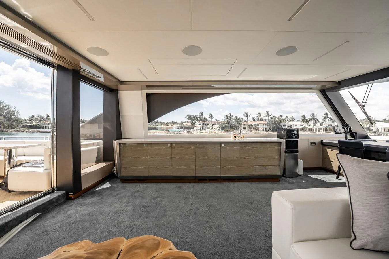 The yacht's interior features a spacious and modern lounge area with large windows offering stunning views. aboard AQUASITION Yacht for Sale