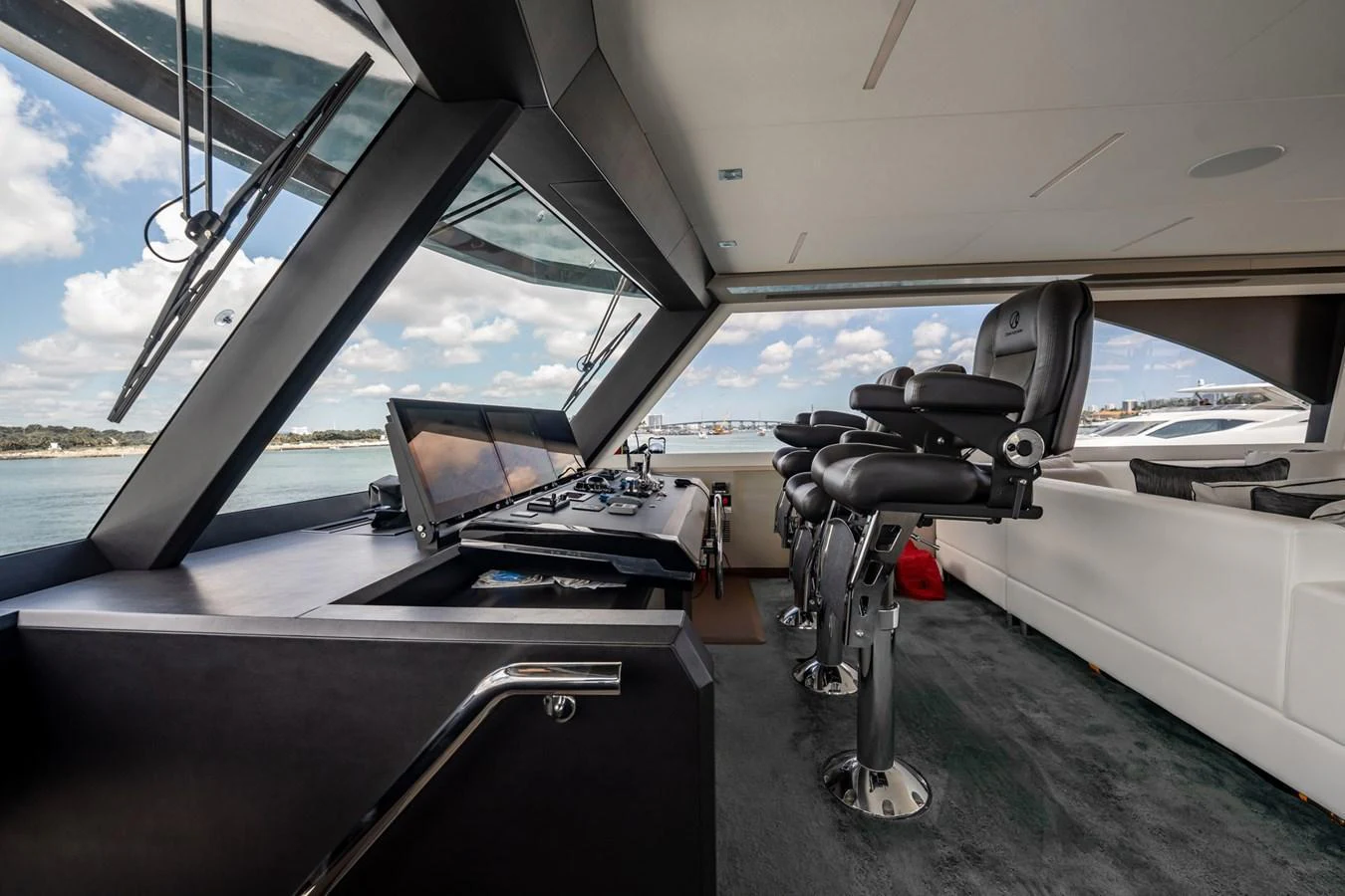 The helm station offers a commanding view with state-of-the-art navigation equipment and luxurious seating. aboard AQUASITION Yacht for Sale