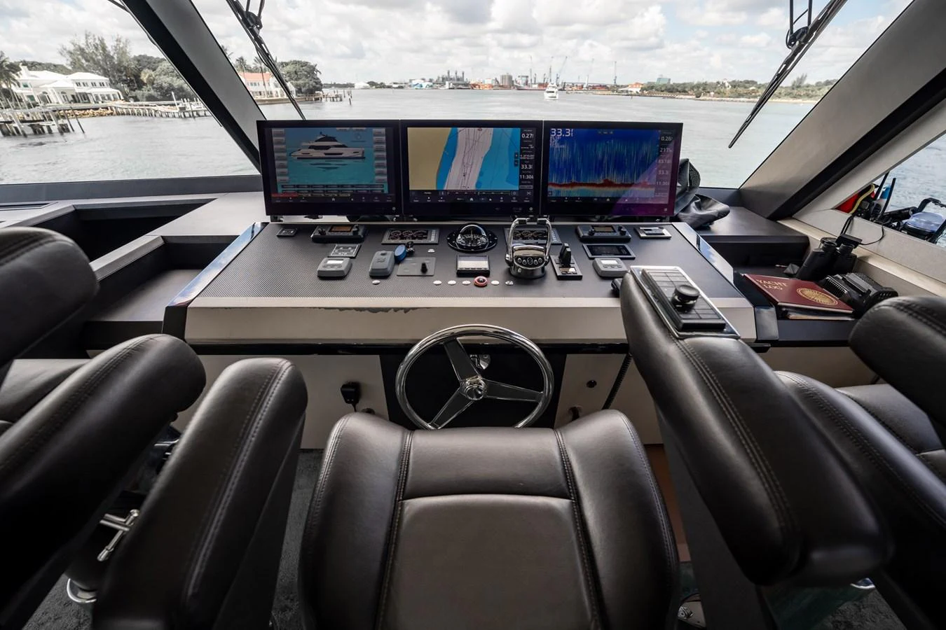 The helm station offers a sophisticated array of navigation and control systems with a panoramic view of the surroundings. aboard AQUASITION Yacht for Sale