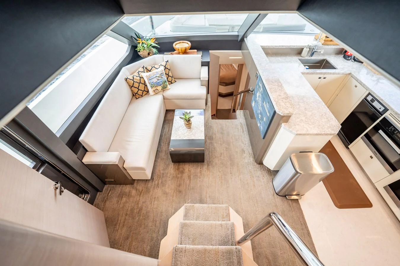 The salon features a cozy seating area with a modern kitchen, creating a welcoming and functional space. aboard AQUASITION Yacht for Sale