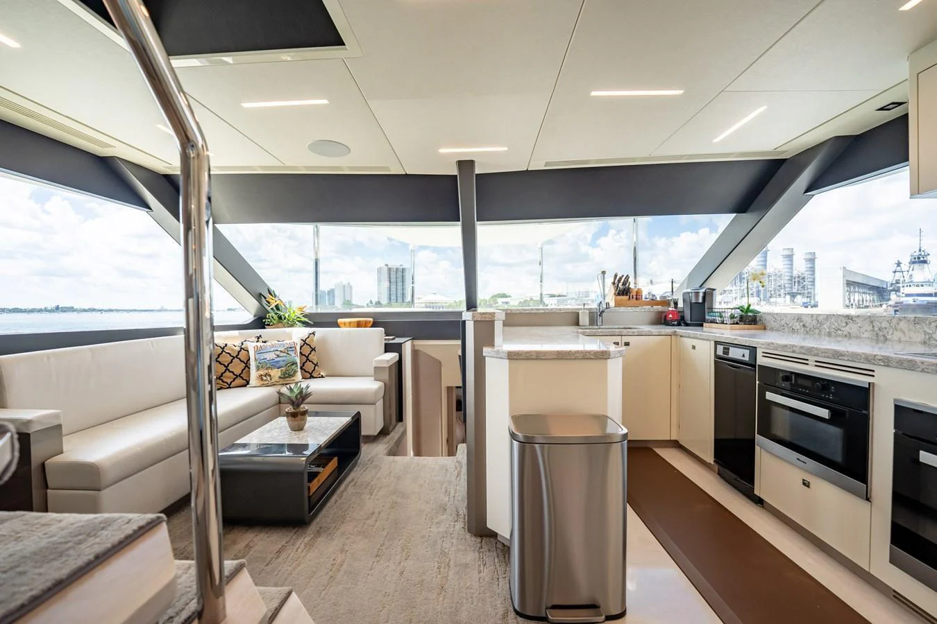 The yacht's galley features modern appliances and a spacious seating area with panoramic views. aboard AQUASITION Yacht for Sale