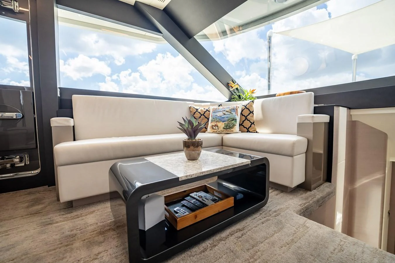 The salon features a modern and comfortable seating area with large windows offering stunning views. aboard AQUASITION Yacht for Sale
