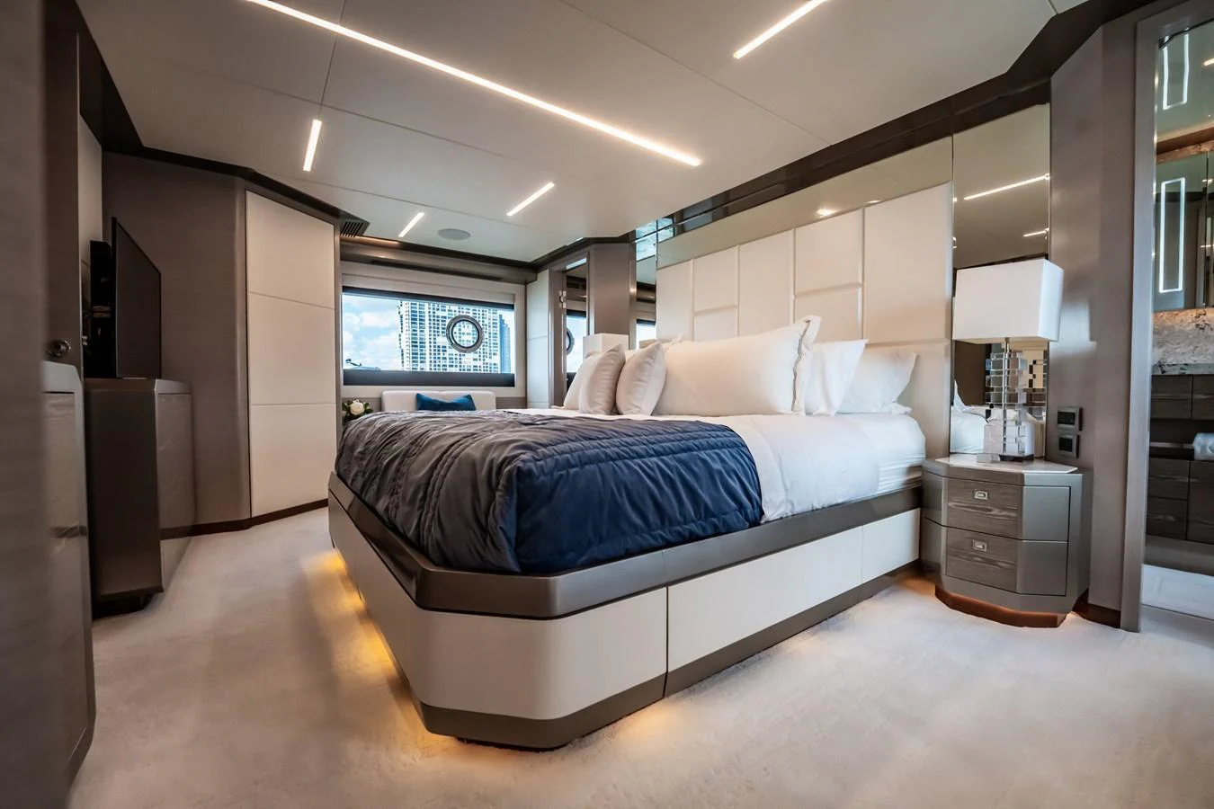 The master stateroom features a luxurious bed with modern lighting and elegant decor. aboard AQUASITION Yacht for Sale