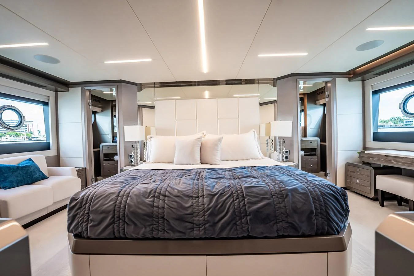The master stateroom features a luxurious bed with elegant decor and ample natural light. aboard AQUASITION Yacht for Sale