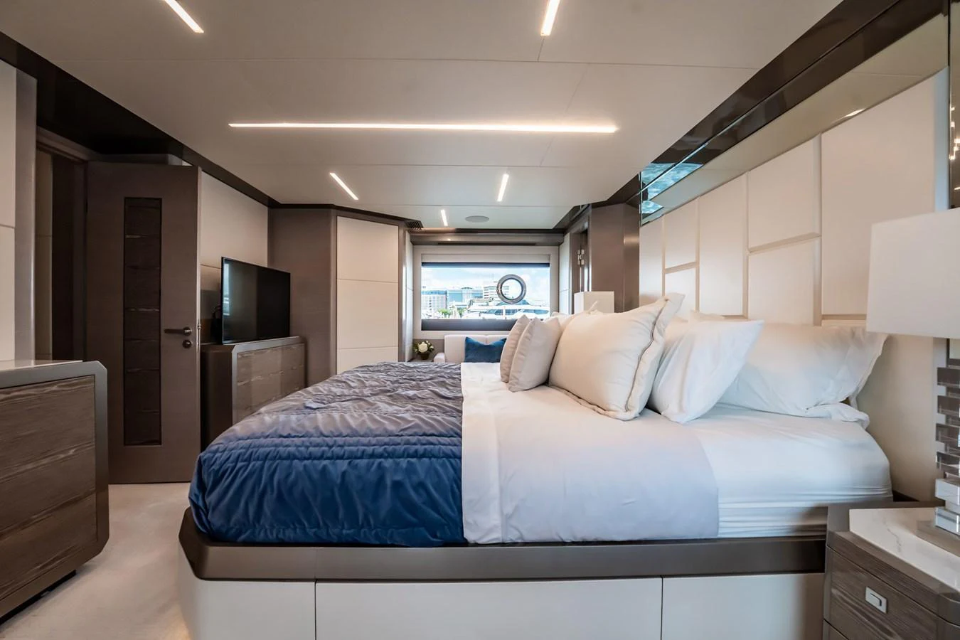 The master stateroom features a luxurious bed with elegant bedding and modern furnishings. aboard AQUASITION Yacht for Sale