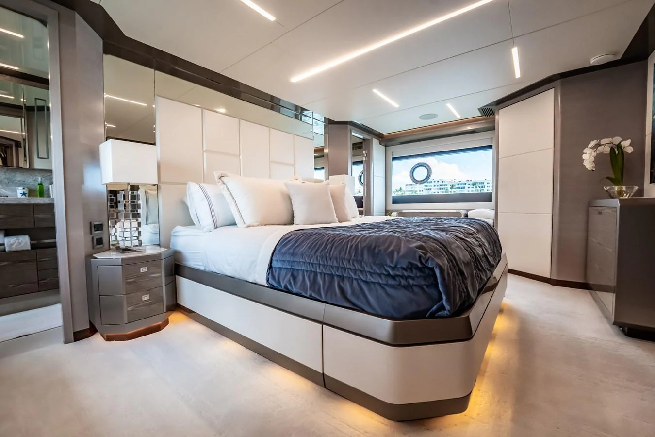 The master stateroom features a luxurious bed with modern decor and ample natural light. aboard AQUASITION Yacht for Sale