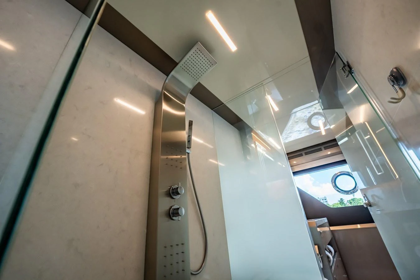 The yacht's bathroom features a sleek, modern shower with luxurious fixtures. aboard AQUASITION Yacht for Sale