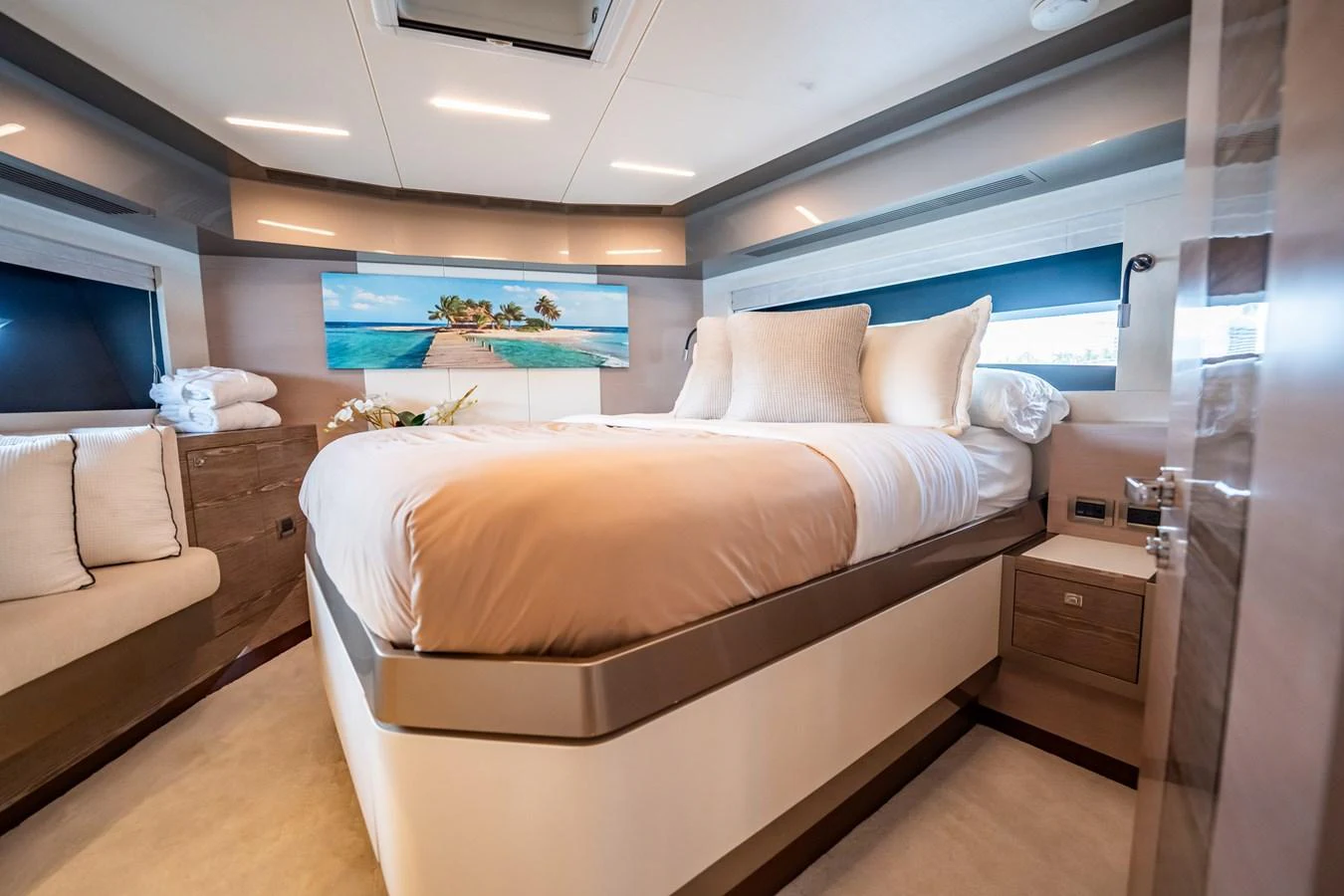 The stateroom features a luxurious bed with plush bedding and serene decor. aboard AQUASITION Yacht for Sale