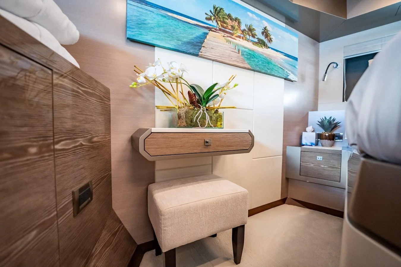 A cozy and elegantly decorated interior space featuring a small seating area and vibrant artwork. aboard AQUASITION Yacht for Sale