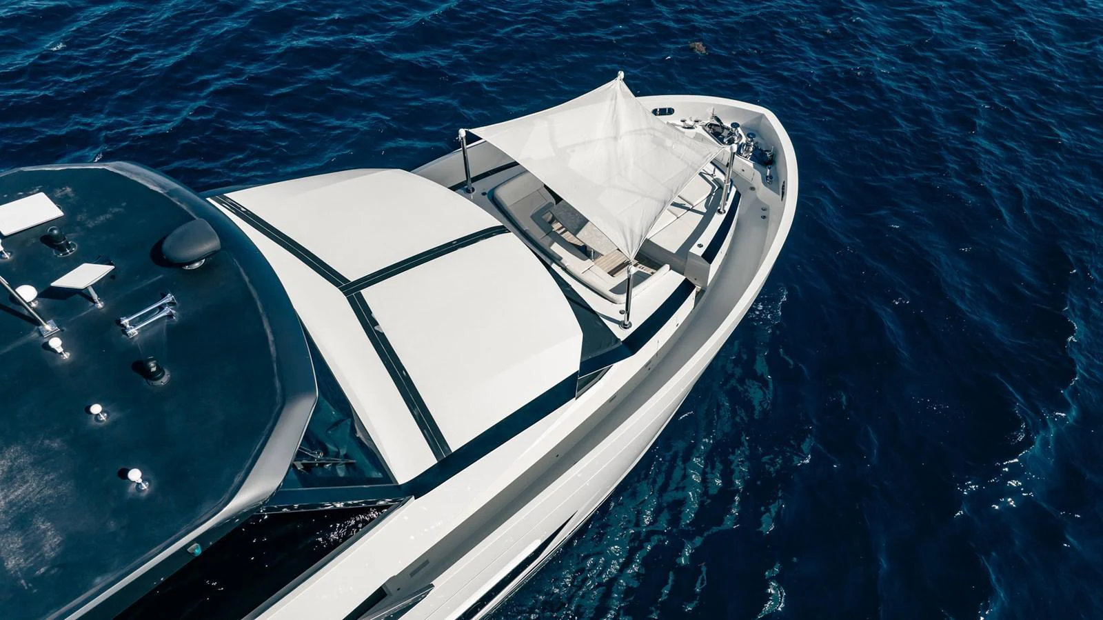 The yacht's foredeck features a sunshade and lounging area, perfect for relaxation on the open sea. aboard AQUASITION Yacht for Sale