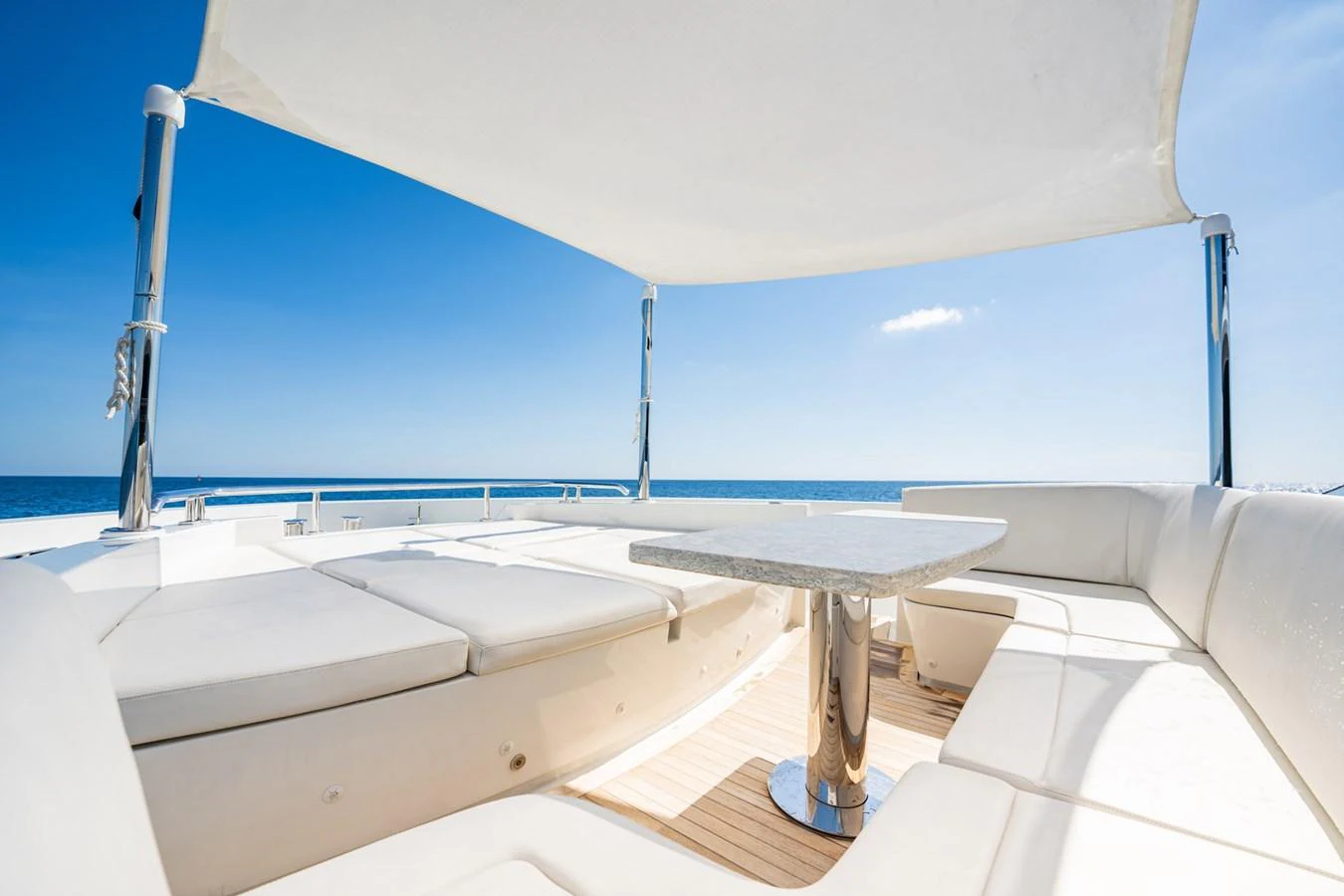 The flybridge offers a spacious and luxurious seating area with a stunning ocean view. aboard AQUASITION Yacht for Sale