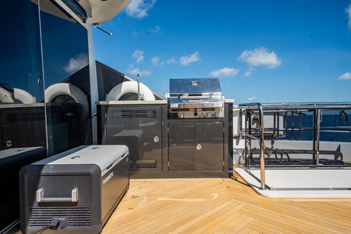 The yacht features a sleek outdoor galley with a grill and ample counter space, perfect for alfresco dining. aboard AQUASITION Yacht for Sale