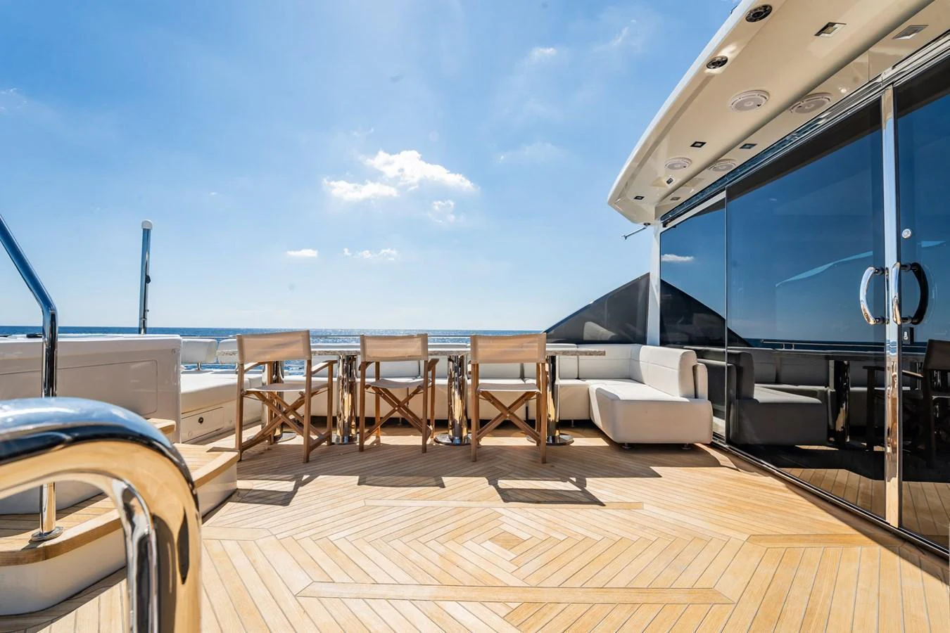 The aft deck offers a spacious and elegant outdoor dining and lounging area with stunning ocean views. aboard AQUASITION Yacht for Sale