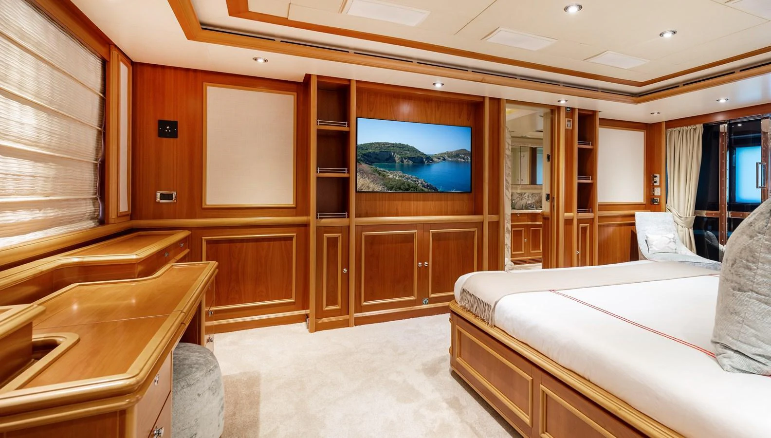 The master stateroom features elegant wood paneling and a large flat-screen TV for ultimate relaxation. aboard EMOTION 2 Yacht for Sale
