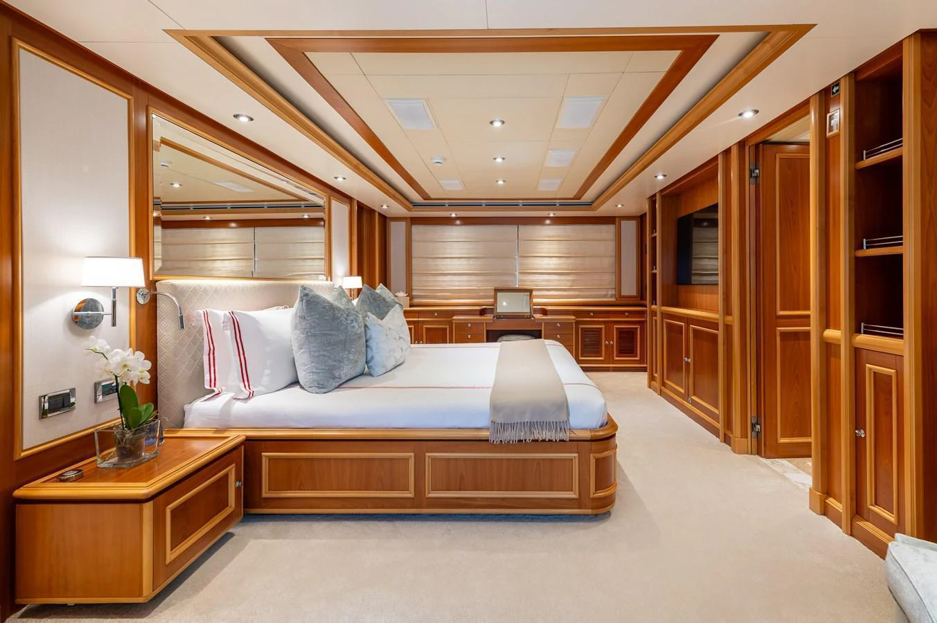 The master stateroom features elegant wood paneling and luxurious bedding for ultimate comfort. aboard EMOTION 2 Yacht for Sale